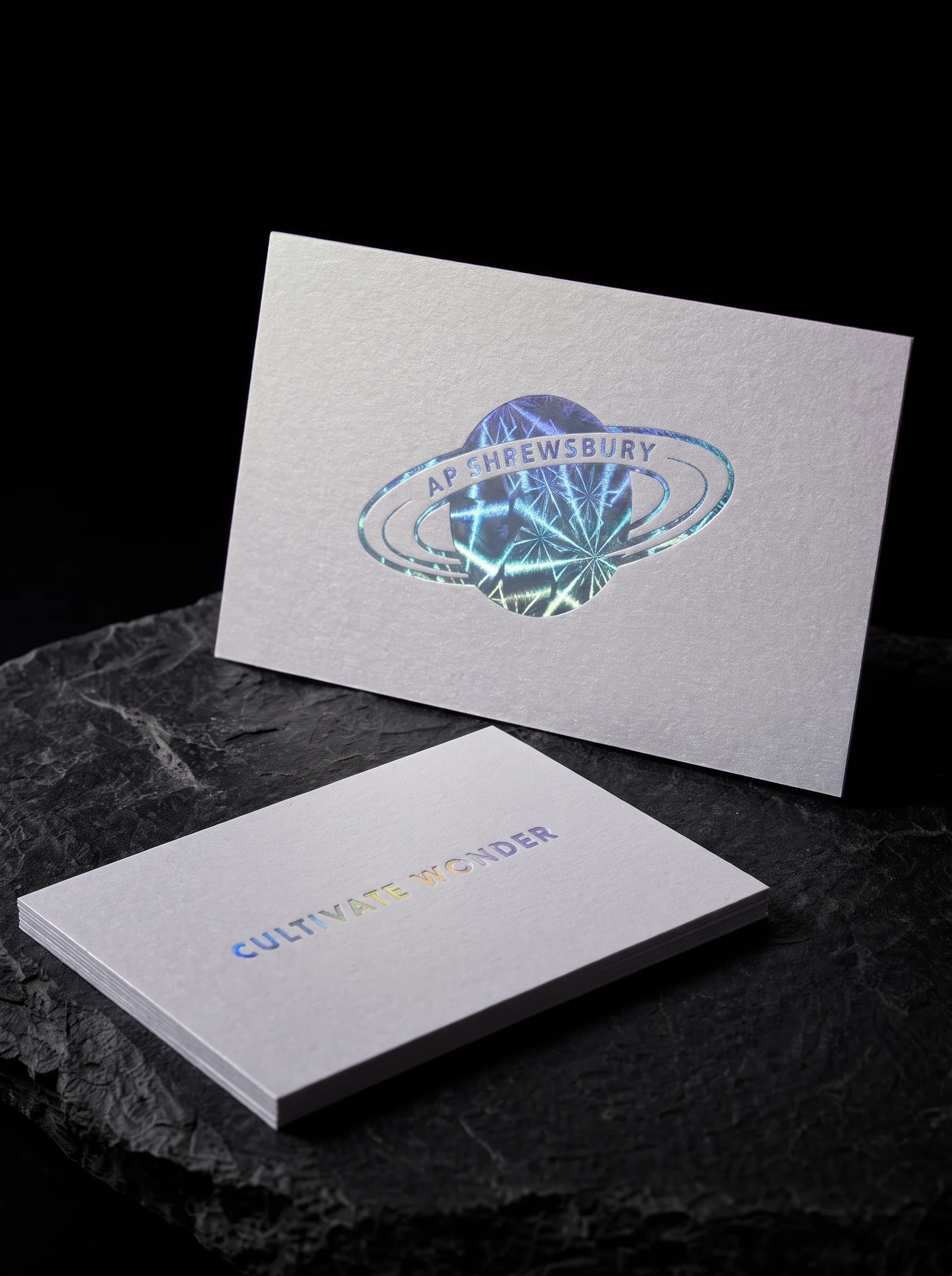Business-cards for AP Shrewsbury with geometric-pattern holographic rainbow foil stamping and pearlized paper.