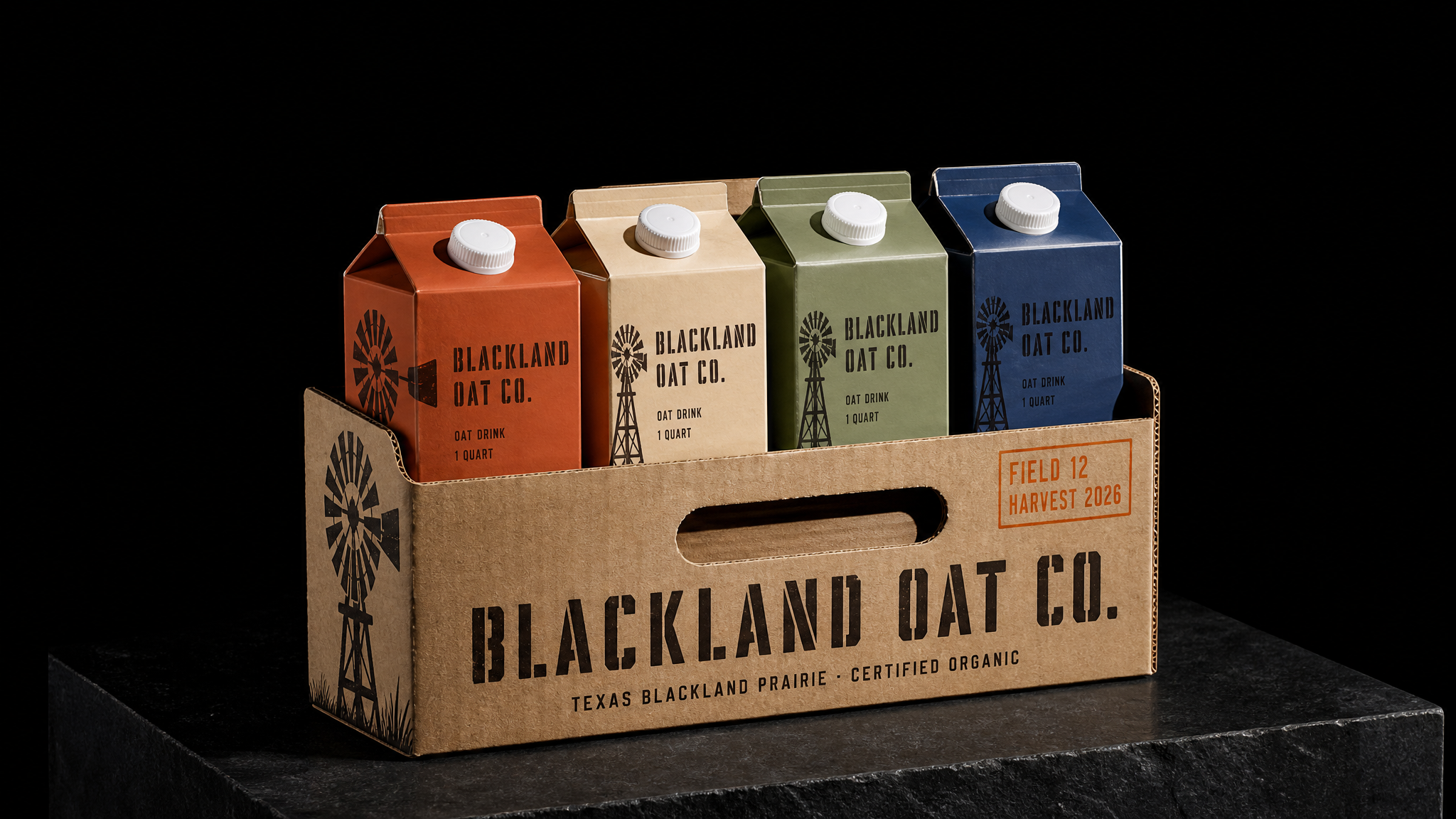 Die-cut kraft four-pack carrier printed in two inks holding four Blackland Oat cartons in burnt orange, oat cream, prairie sage and deep indigo