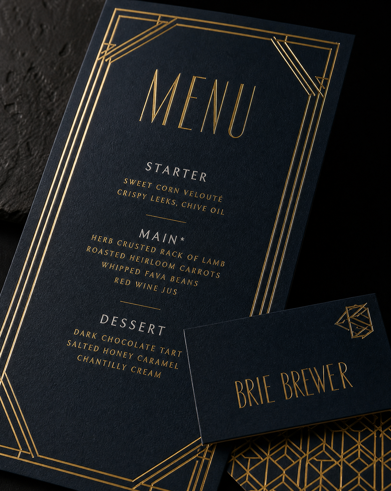 Close detail of the Brie Brewer wedding menus programs — Menu 4 × 9 in; place card 3.5 × 2 in, 32pt midnight navy uncoated, Gold hot foil, White ink.