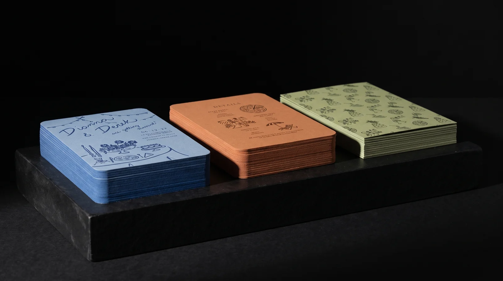 Paper edges and coloured layers of the wedding suite on a black plinth, simulated before press