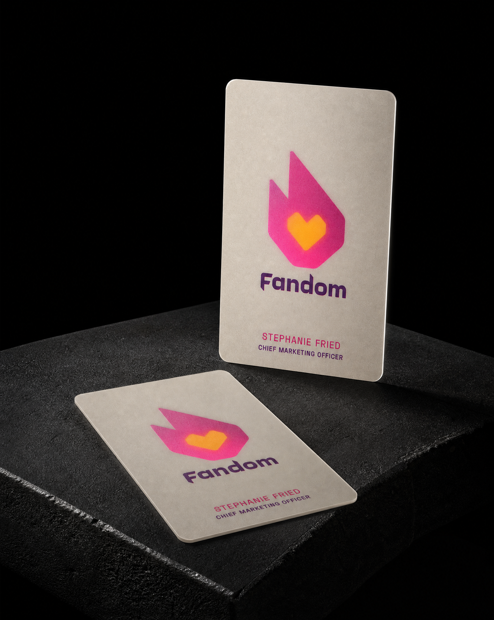Business-cards for Fandom with 2.125 × 3.375 in vertical, 3 mm rounded corners, 30pt frosted pvc, opaque white flood, knocked out to shape, two-sided print: mark on the reverse, type on the and no die cut, no laminate.