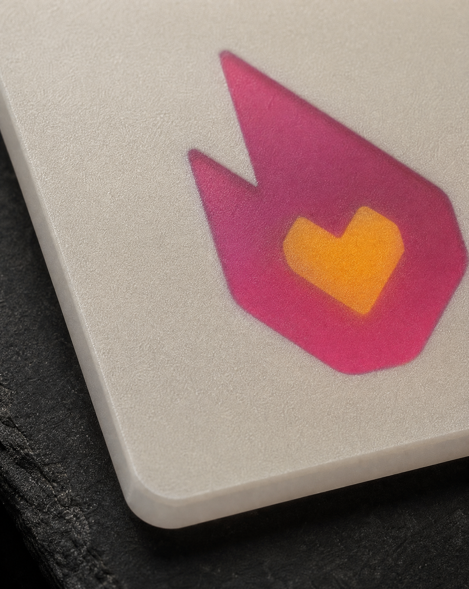 Macro of the boundary between opaque frosted PVC and the translucent Fandom flame mark