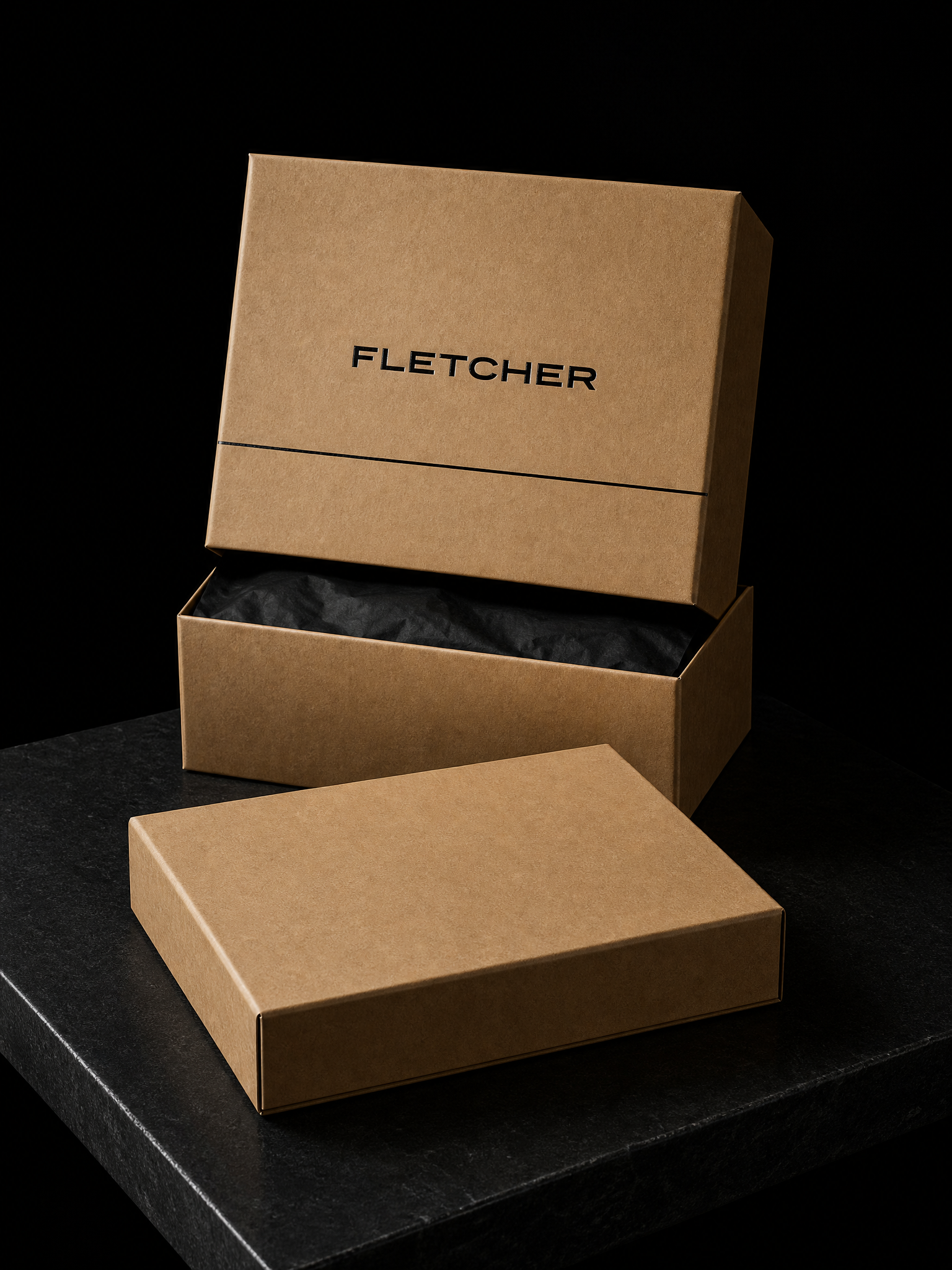 Boxes for Fletcher with black foil stamping, rigid 9×12×4 in, natural kraft wrap and black tissue.
