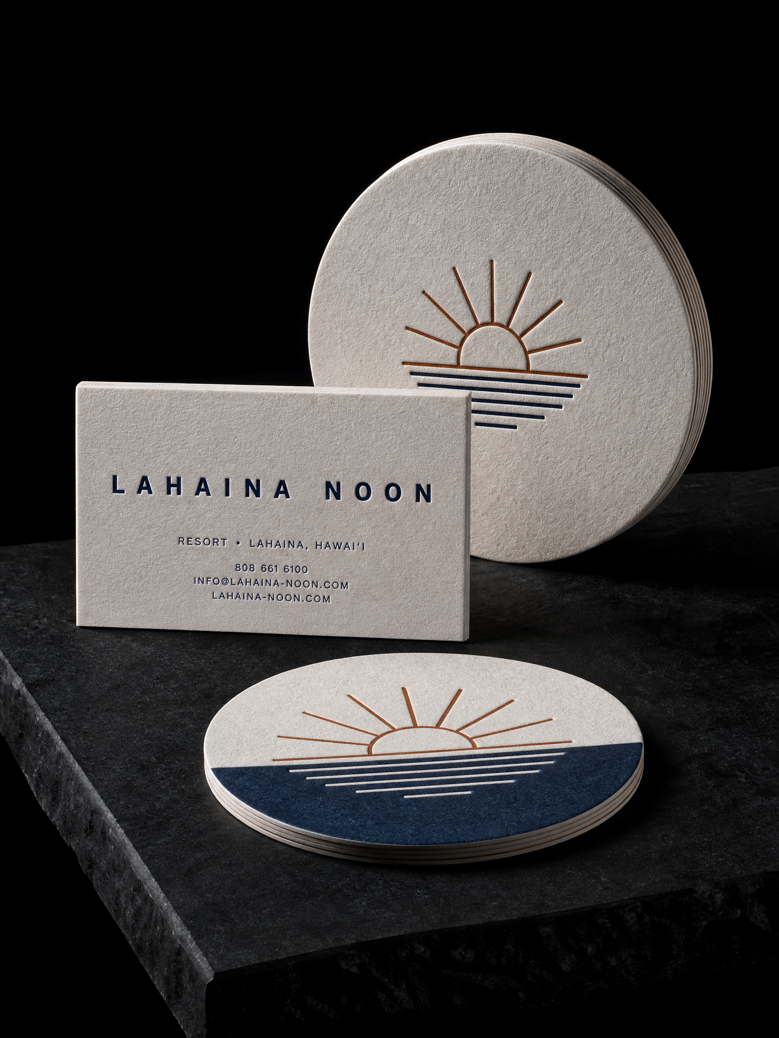 Business-cards for Lahaina Noon with 32pt off-white cotton, navy letterpress, heavyweight coaster board, 4 in round and 4-colour process, two-sided.