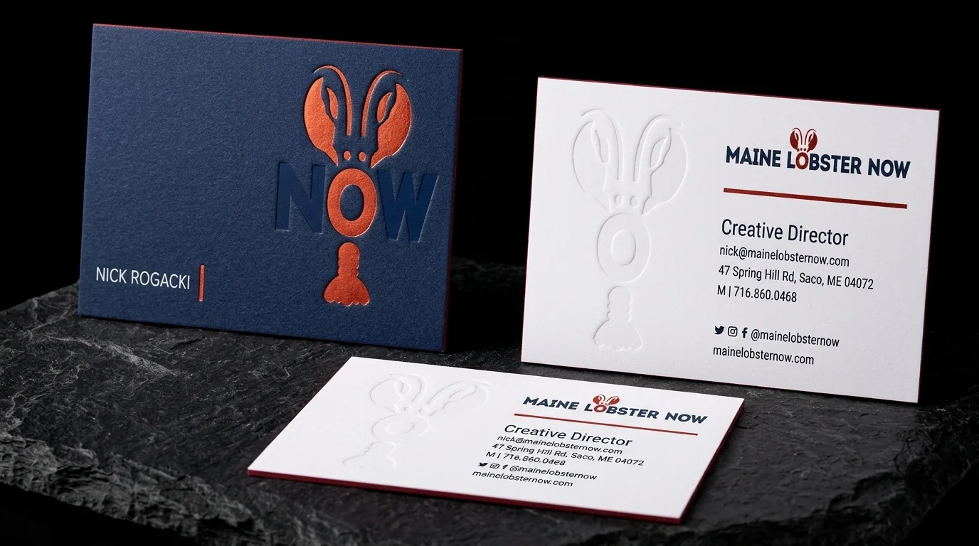 Business-cards for Maine Lobster Now with red-orange foil stamping, navy + white duplex, blind emboss and red painted edge.