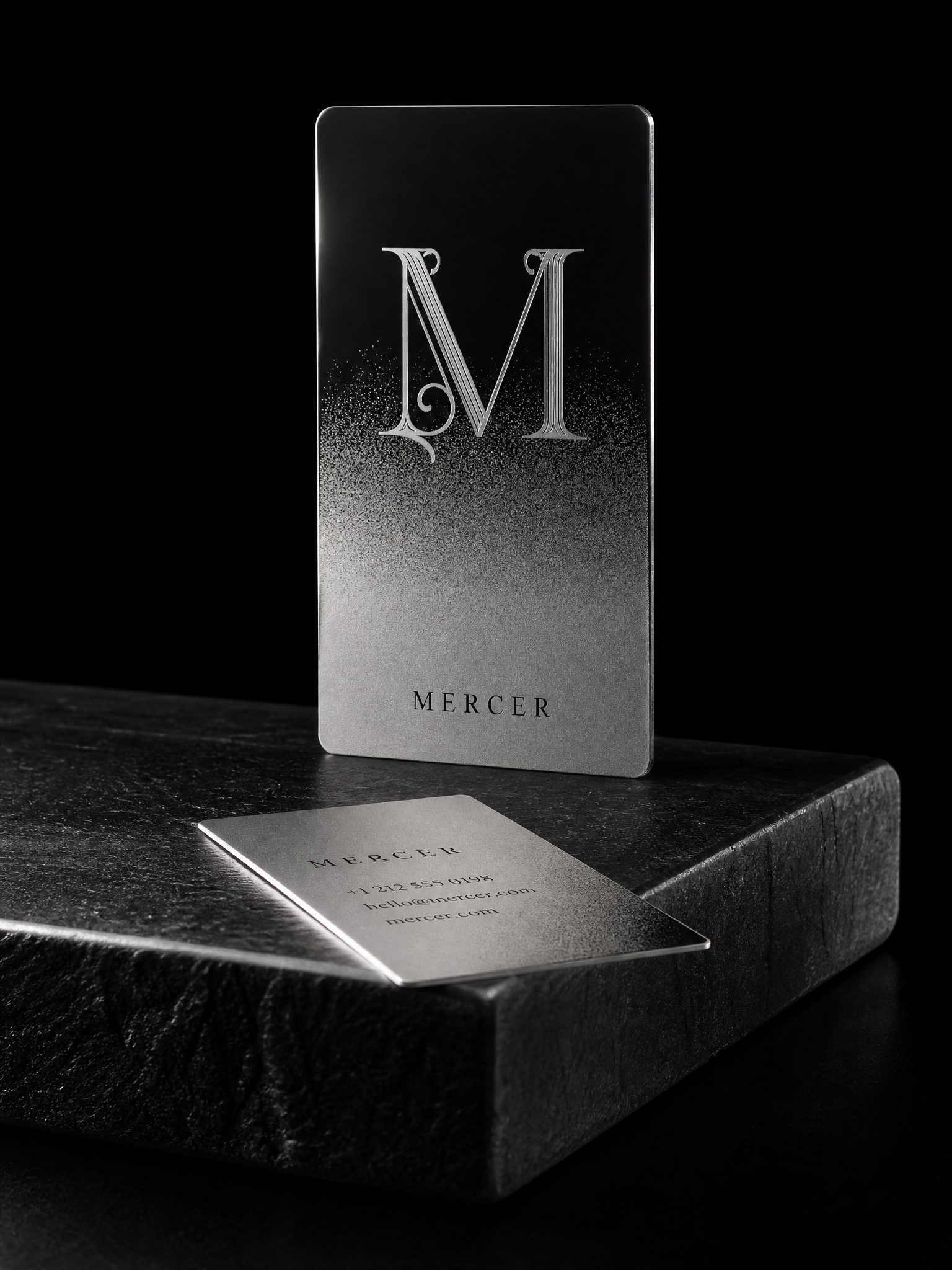 Stainless mirror-to-matte gradient serif M — custom metal business card by Print Peppermint, stainless steel with mirror finish
