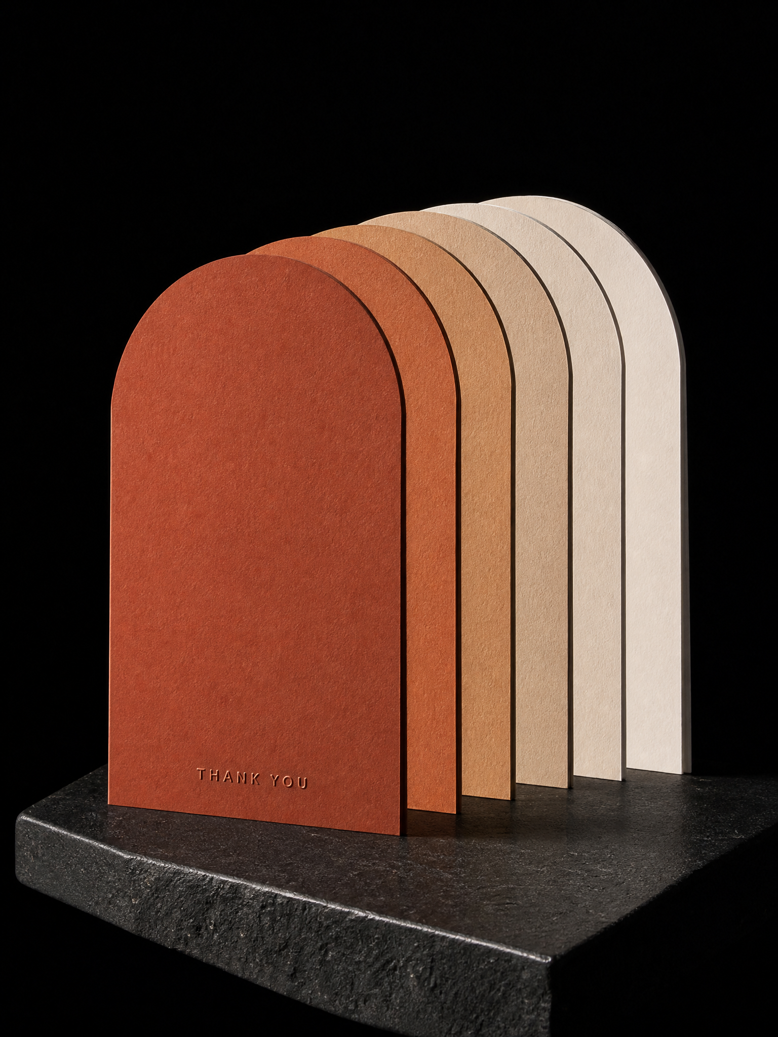 Notecards for Print Peppermint design exercise with six arch-topped flat cards 3×5 in, 32pt, fanned so the arches step down, stocks graded from deep terracotta through clay to cream; each carries "thank you" in tiny blind-debossed caps near the foot.