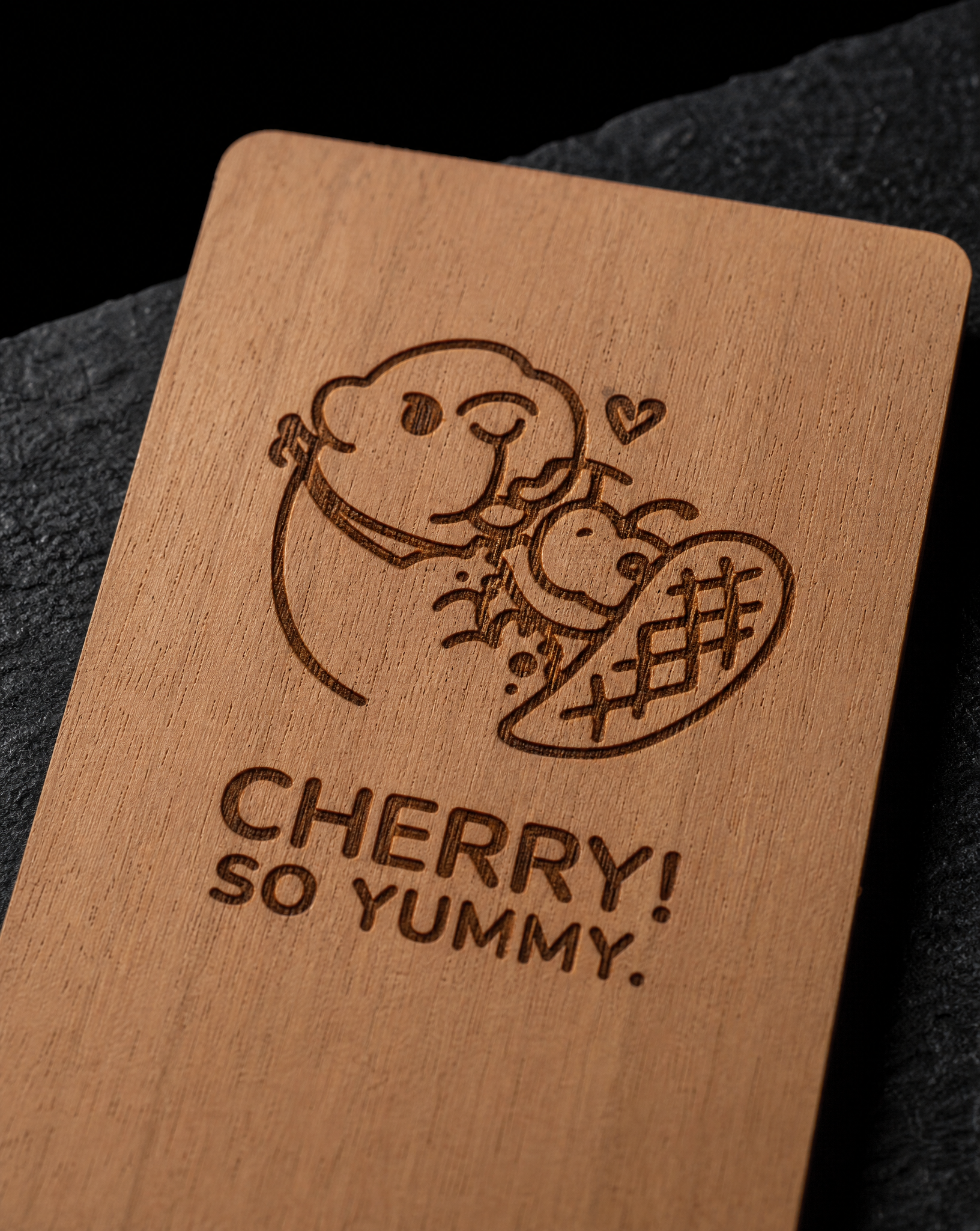 Macro of laser engraving in solid cherry wood showing the burn inside the grain