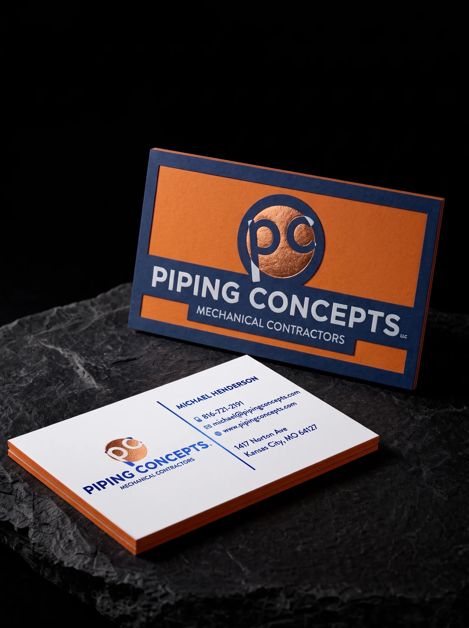 Business-cards for Piping Concepts with copper and blue foil stamping, three-layer construction, blue uncoated face, orange uncoated middle, white uncoated face and two-sided.