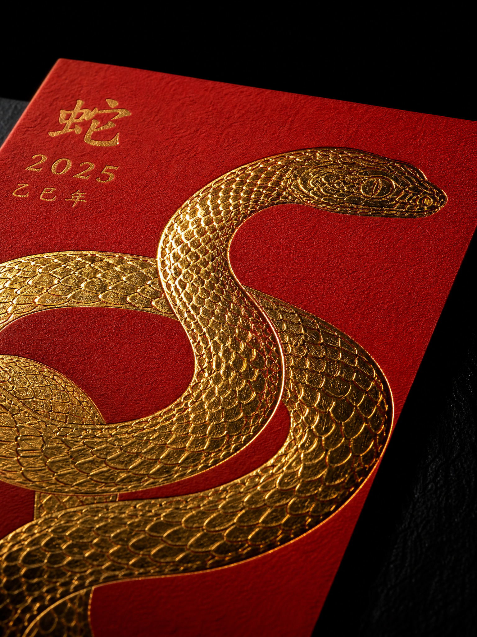 Macro of the gold foil serpent on red stock