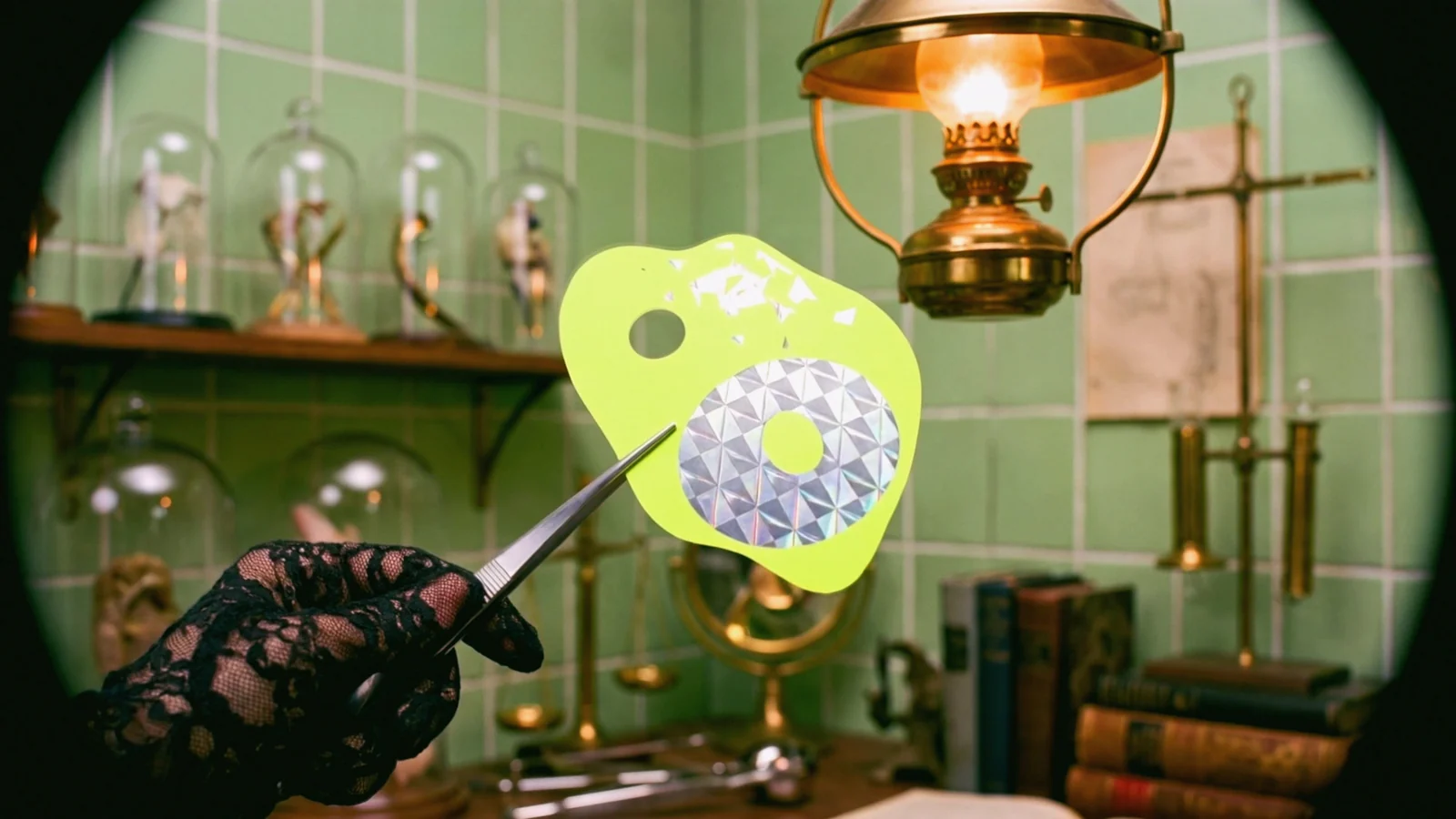 Tweezers lift the card and the room turns to colour