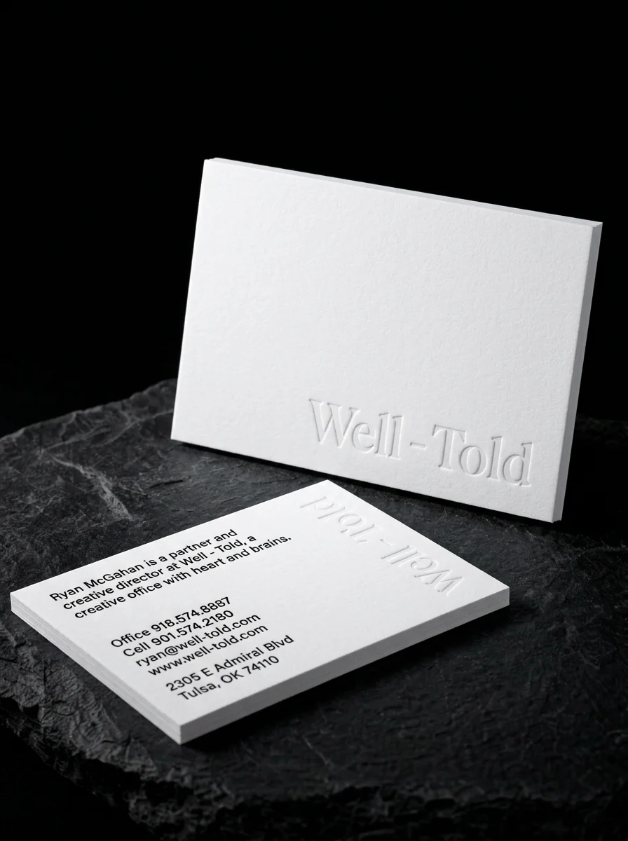 White business card with a vertical blind embossed name and no ink on the front