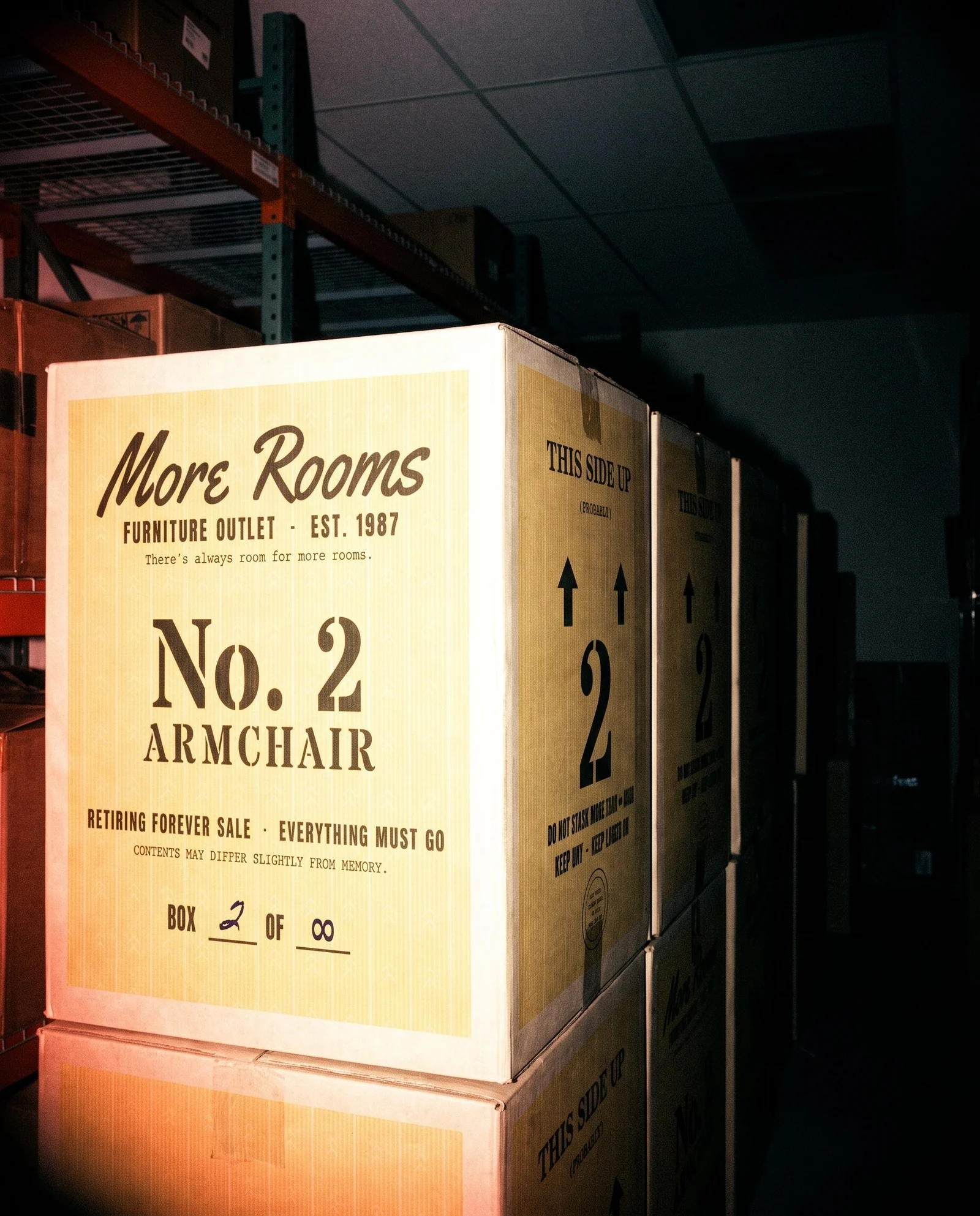 On-camera flash snapshot of a stack of yellow printed boxes in a dark stockroom