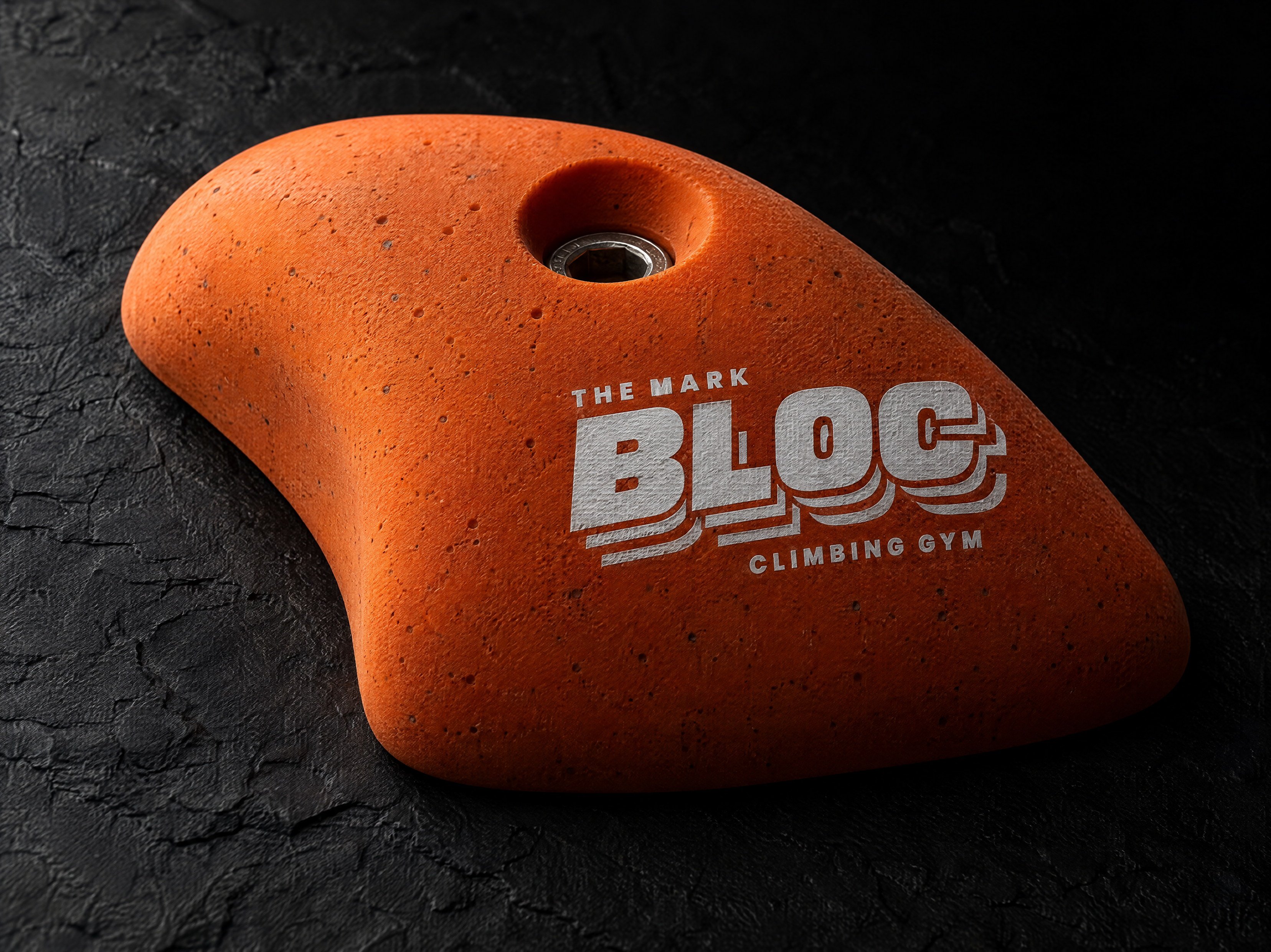 BLOC logo and brand identity for a bouldering gym, designed by Print Peppermint, shown as a chalk-white thick silkscreen print sitting raised on the hold