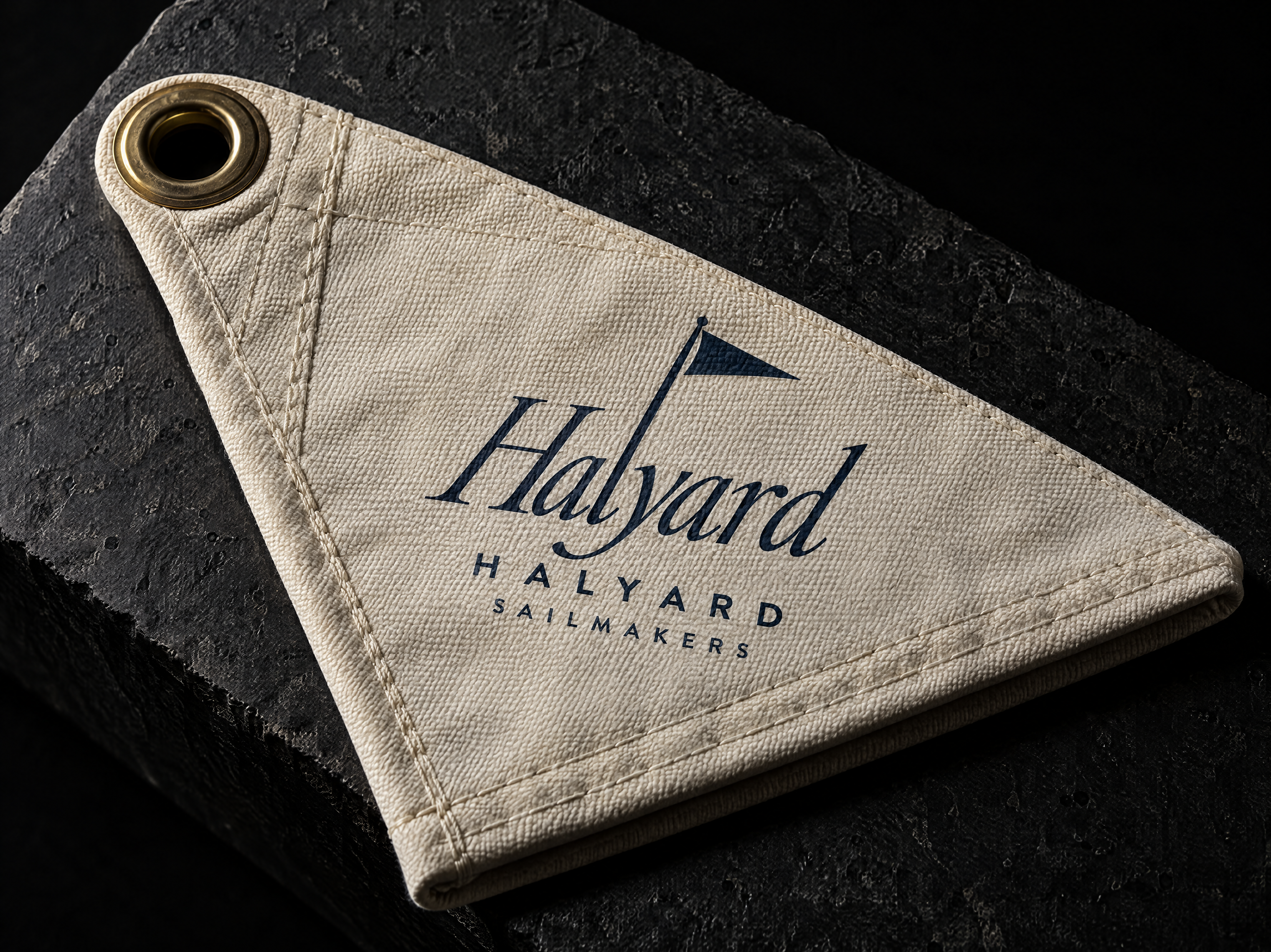 Halyard logo and brand identity for a traditional sail loft, designed by Print Peppermint, shown as a navy single-colour screen print on the canvas