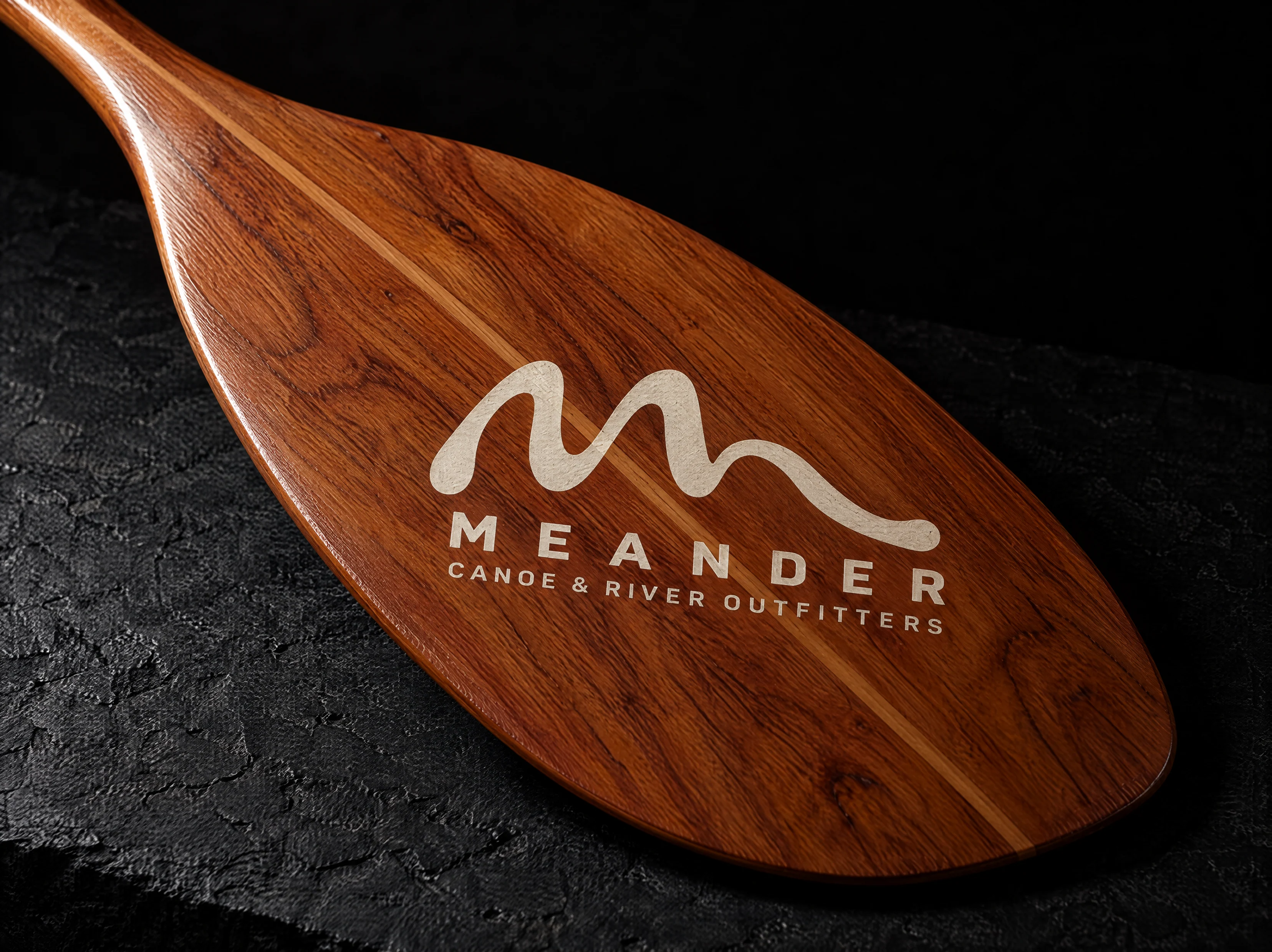 Meander logo and brand identity for a canoe and river-trip outfitter, designed by Print Peppermint, shown in application
