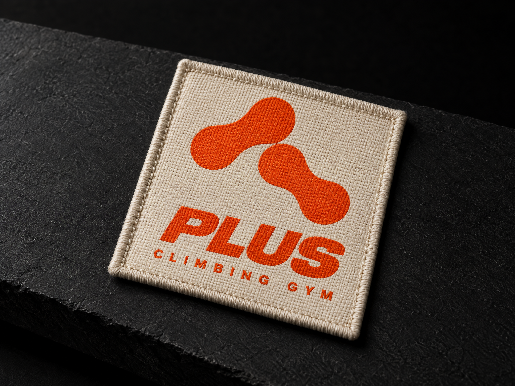 PLUS climbing gym identity, designed by Print Peppermint, embroidered in orange and red on a woven patch