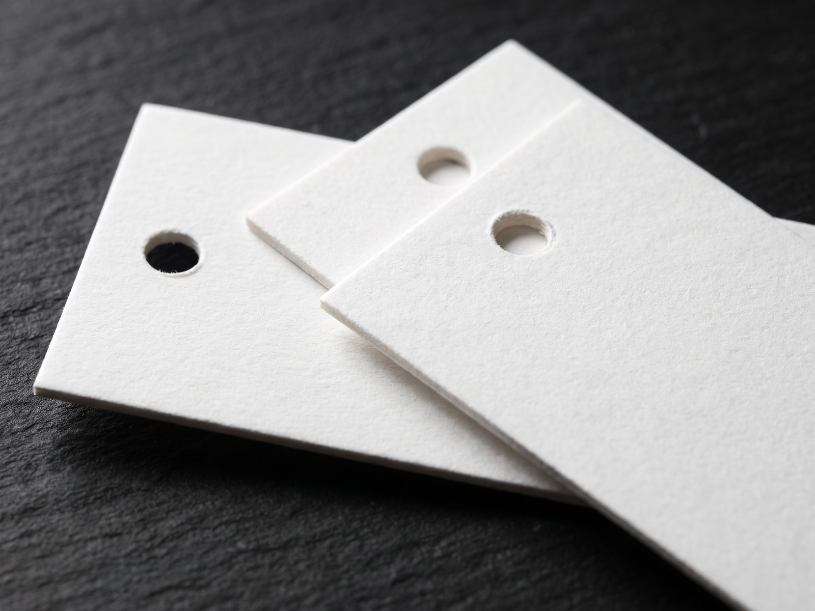 Clean drilled hole through a printed hang tag