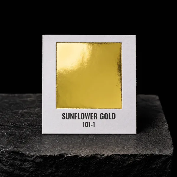 Sunflower Gold 101-1 foil chip photographed on slate