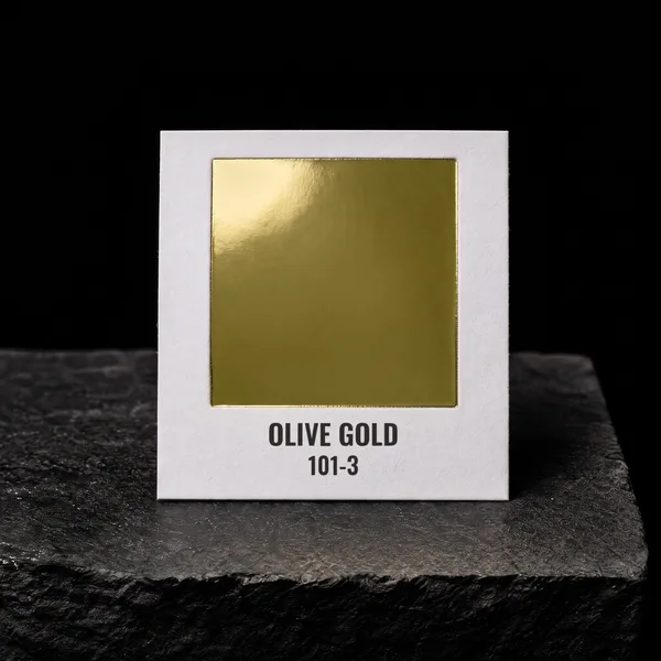 Olive Gold 101-3 foil chip photographed on slate