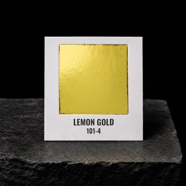 Lemon Gold 101-4 foil chip photographed on slate
