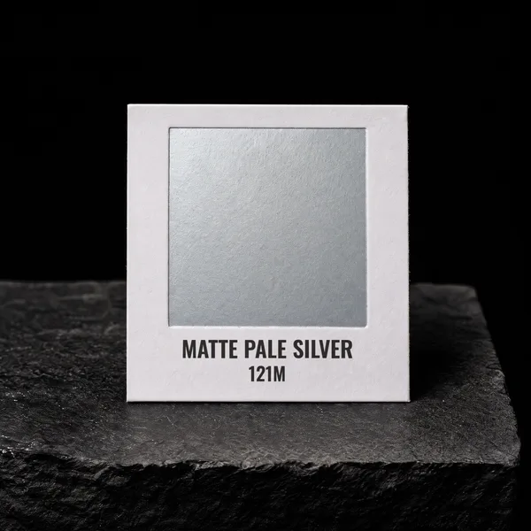 Matte Pale Silver 121M foil chip photographed on slate