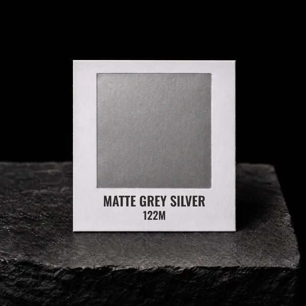 Matte Grey Silver 122M foil chip photographed on slate