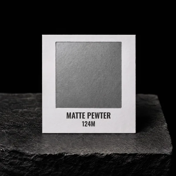 Matte Pewter 124M foil chip photographed on slate