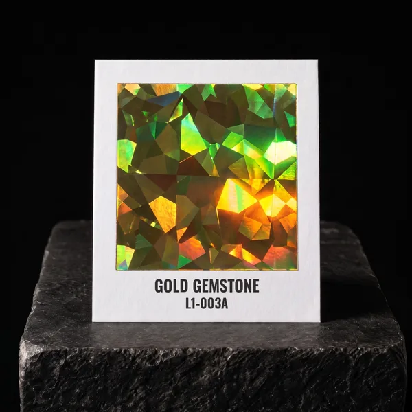 Gold Gemstone L1-003A foil chip photographed on slate
