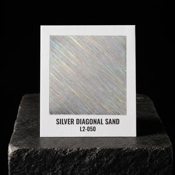 Silver Diagonal Sand L2-050 foil chip photographed on slate