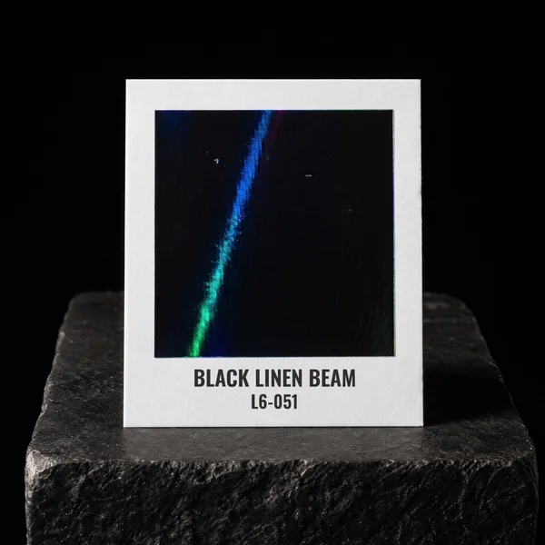 Black Linen Beam L6-051 foil chip photographed on slate