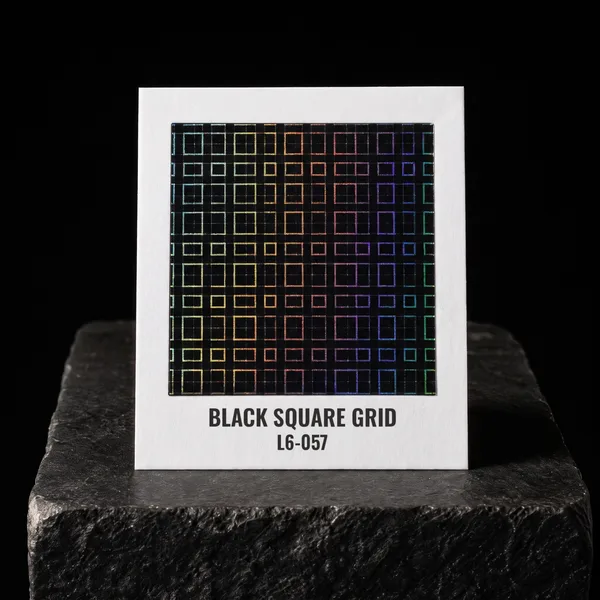 Black Square Grid L6-057 foil chip photographed on slate