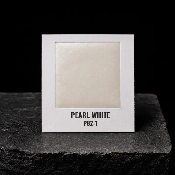 Pearl White P82-1 foil chip photographed on slate