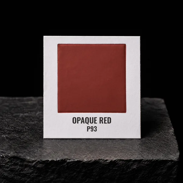 Opaque Red P93 foil chip photographed on slate