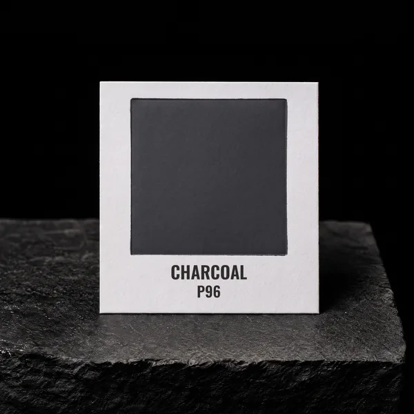 Charcoal P96 foil chip photographed on slate