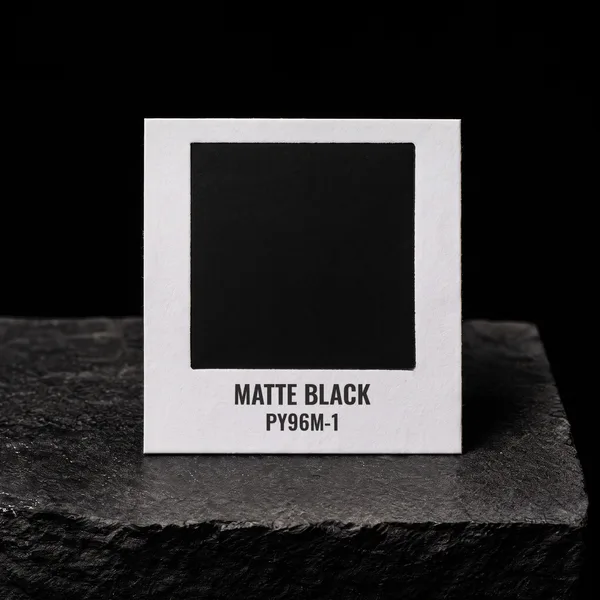 Matte Black PY96M-1 foil chip photographed on slate