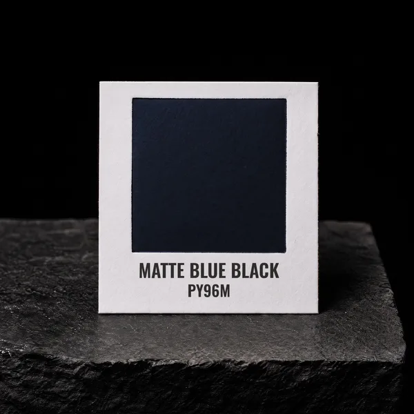 Matte Blue Black PY96M foil chip photographed on slate