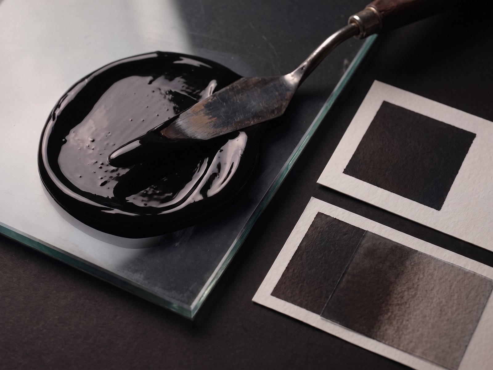 Blacks spot ink mixed on glass with paper drawdowns