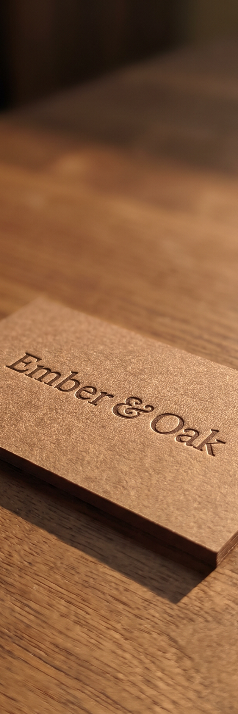 Business card with blind deboss and registered emboss on 14pt fedrigoni savile-row brown stock.