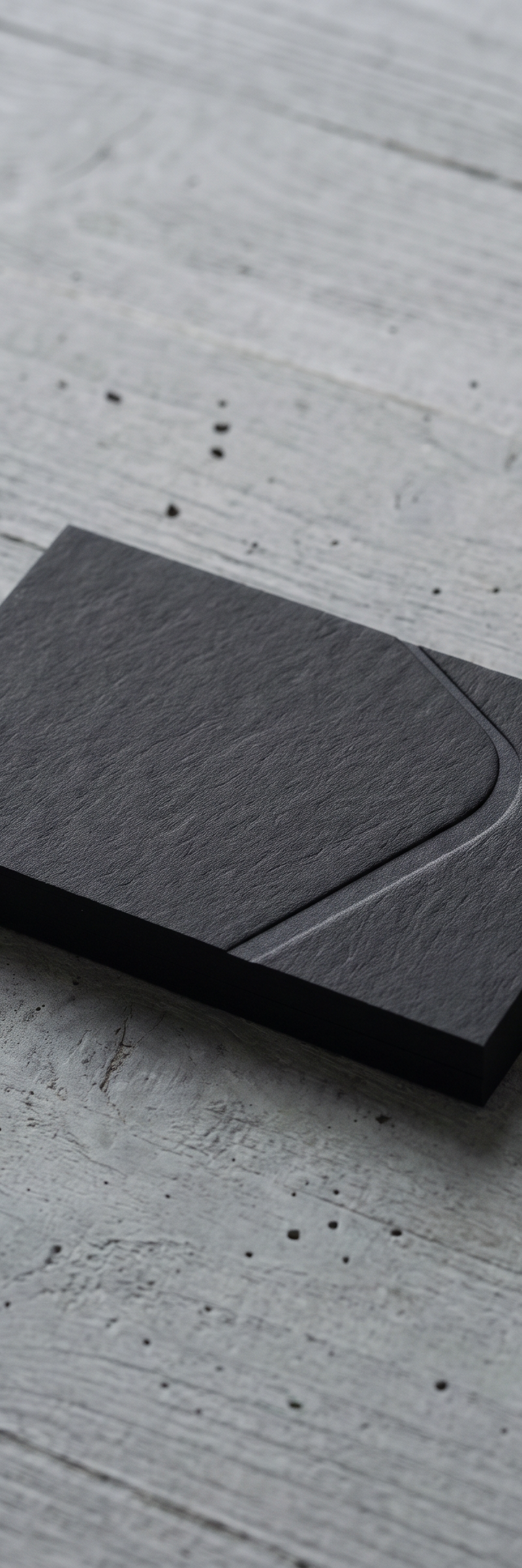 Business card with blind deboss on 530gsm gmund gmund-heidi dull black stock.