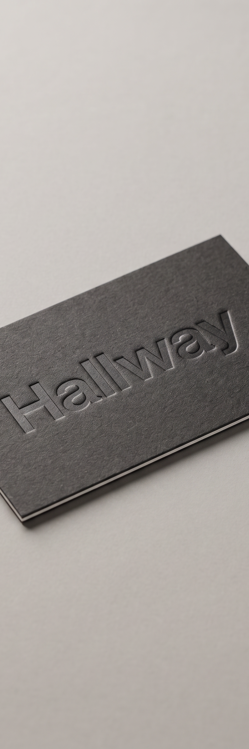 Business card with blind deboss and core visible edges on fedrigoni materica pitch stock.