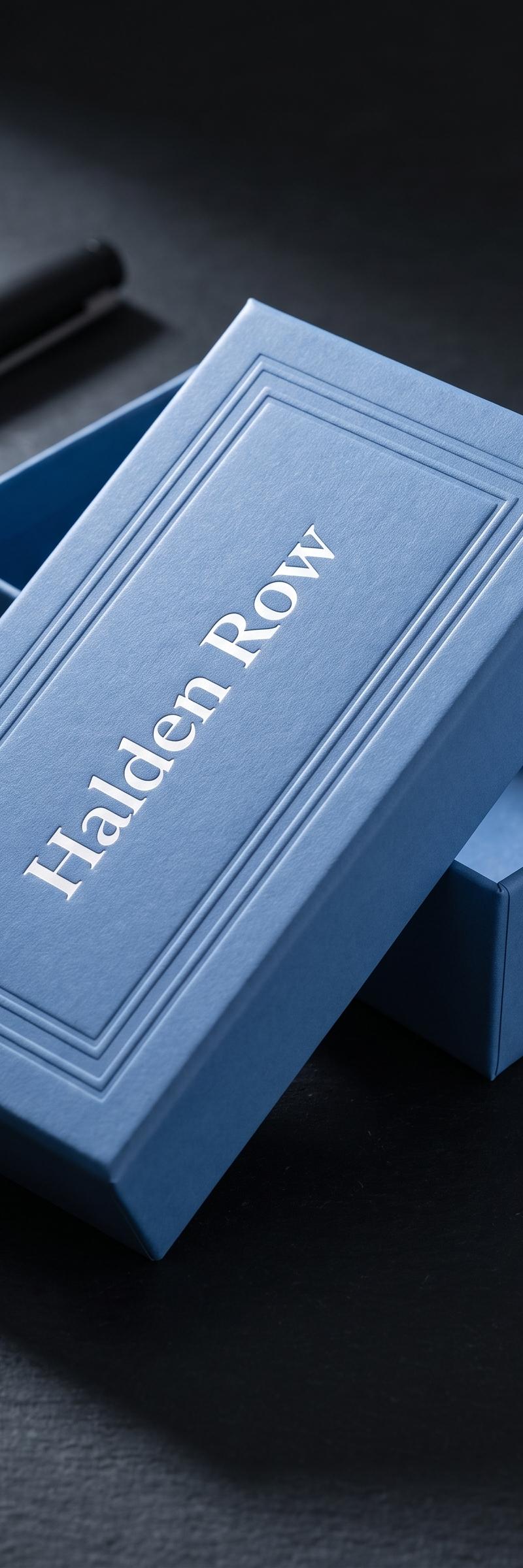 Merch with opaque-white foil stamping and blind deboss on house coated-uncoated rigid box board.