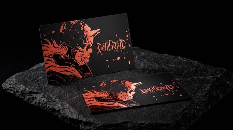 DevilGrind black business card: Full-bleed illustration on matte black with raised gloss over the red