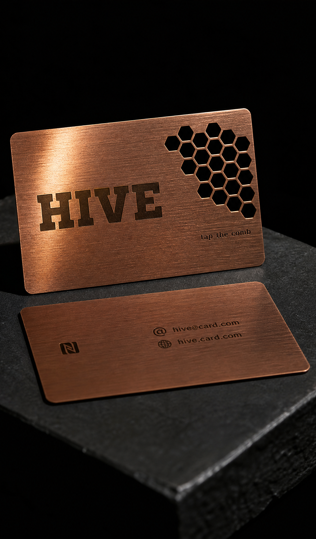 Copper-tone metal NFC card with a honeycomb cut-through over the antenna window