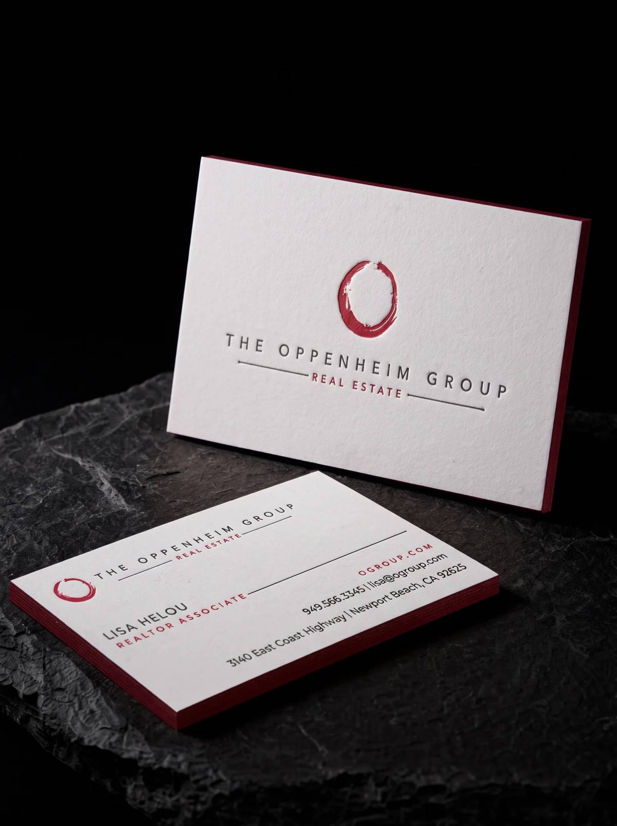 White cotton business card with charcoal and red letterpress and a red painted edge