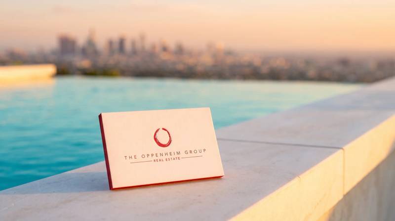 The Oppenheim Group letterpress business card: Two-color letterpress on bright white 100% cotton, PMS-matched red painted edge