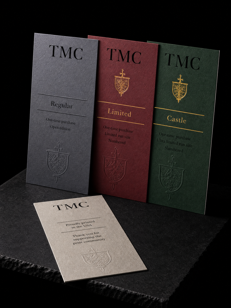 Three 4 by 6 inch box insert cards in three solid colors, the top two carrying a small gold foil crest.