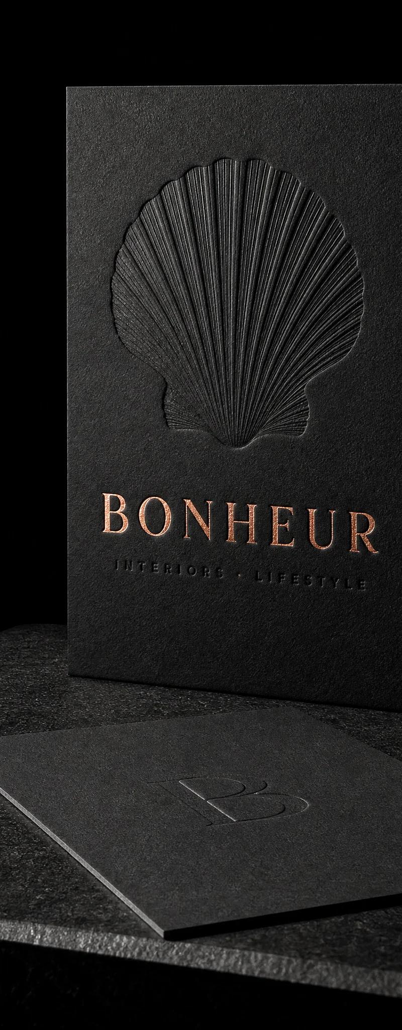 Business card with copper- foil stamping and deboss.