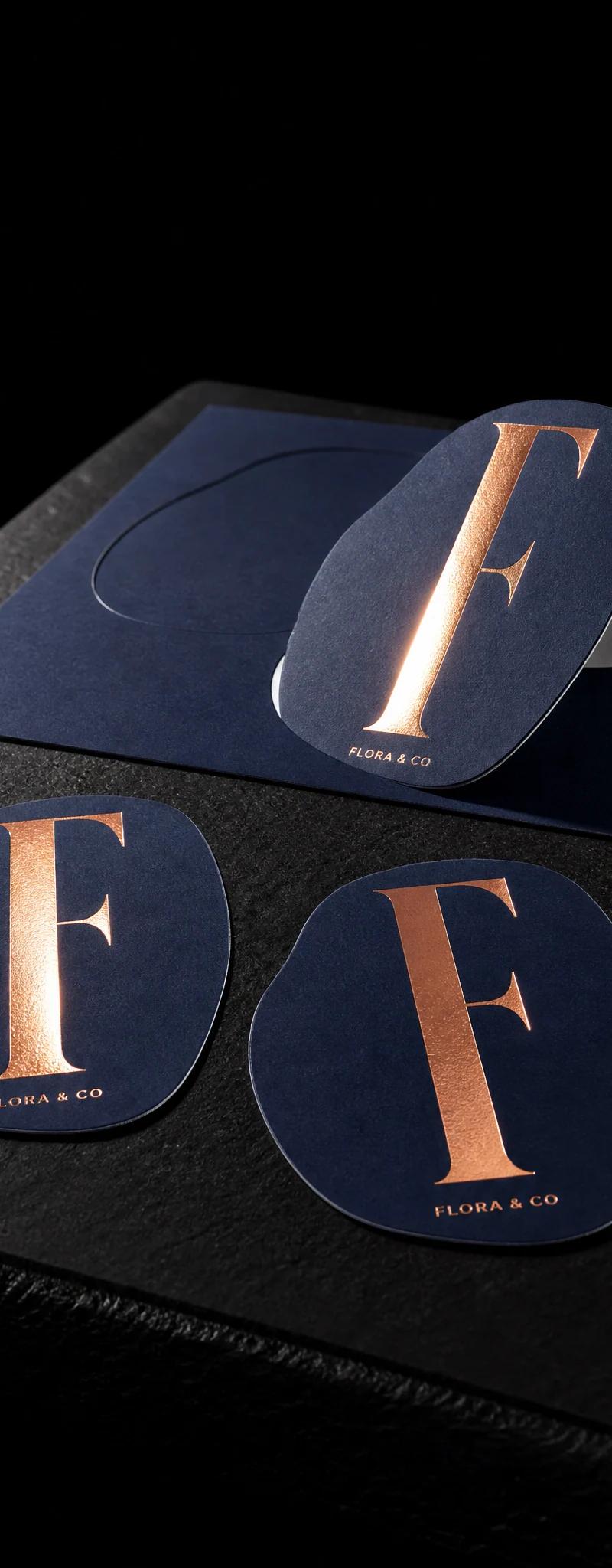 Business card with copper- foil stamping and die-cut.
