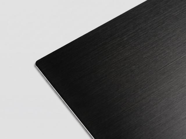 Brushed black metal paper swatch — black with brushed grain